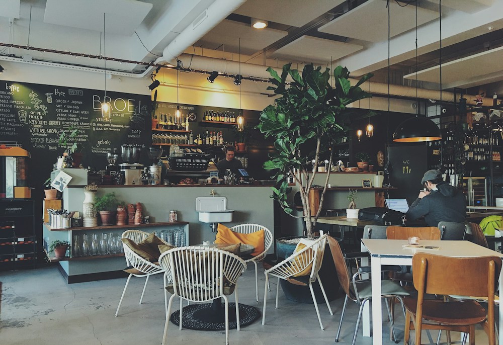 Warm café interior with tables and a coffee bar